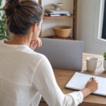 Small-business operator reviewing a blank weekly calendar beside a closed laptop